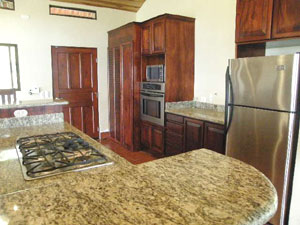 Casa Fiesta is fully outfitted with fine appliances including a gas range built into the large kitchen island.